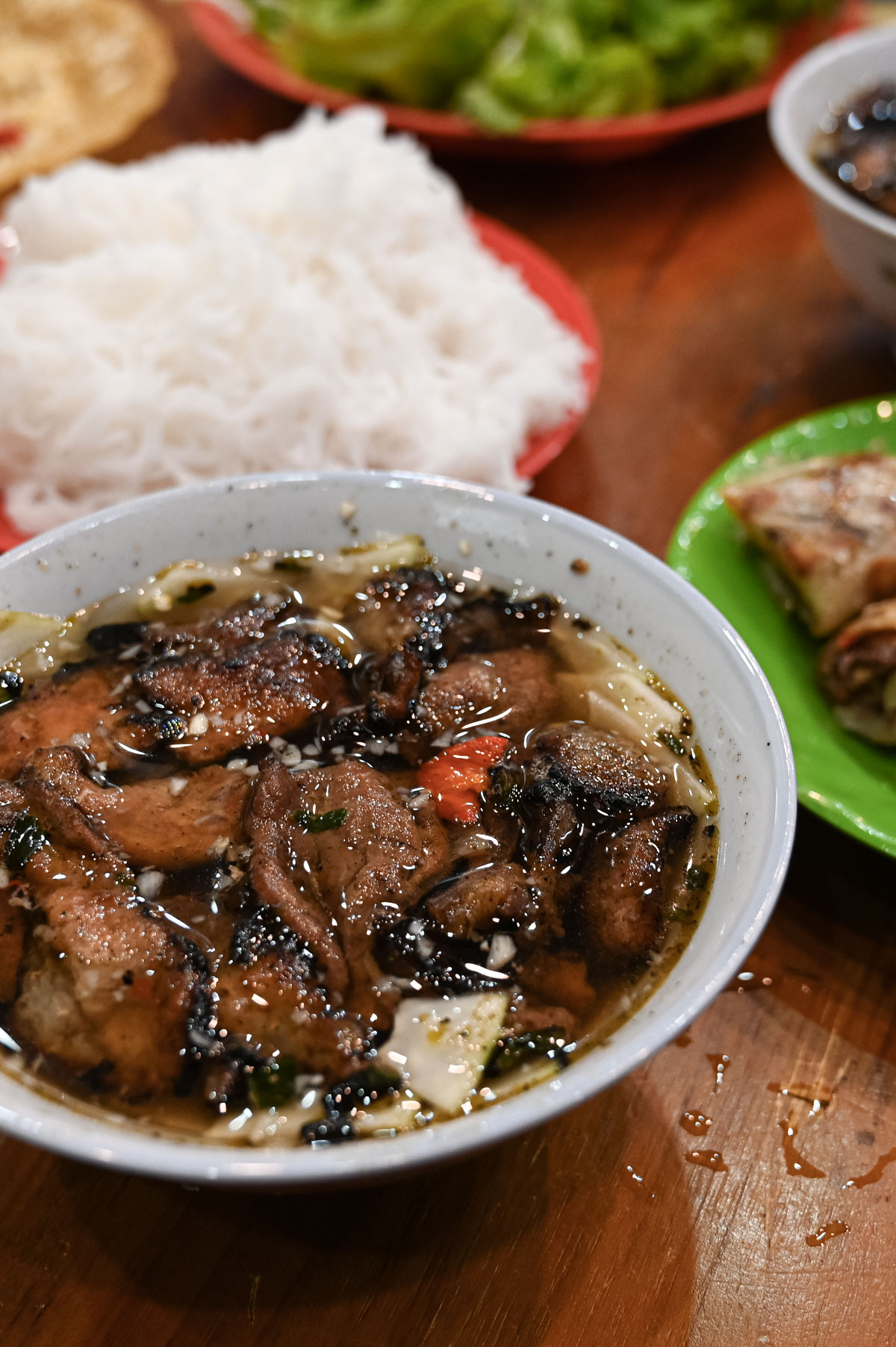 A bowl of Vietnamese grilled pork in dipping sauce